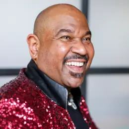 David Moore wearing a red sequined coat