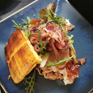 Burger filled with Pulled Ginger Turkey on blue plate